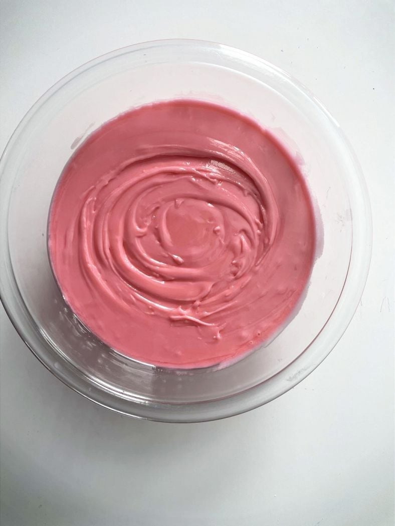 thick pink royal icing in a bowl